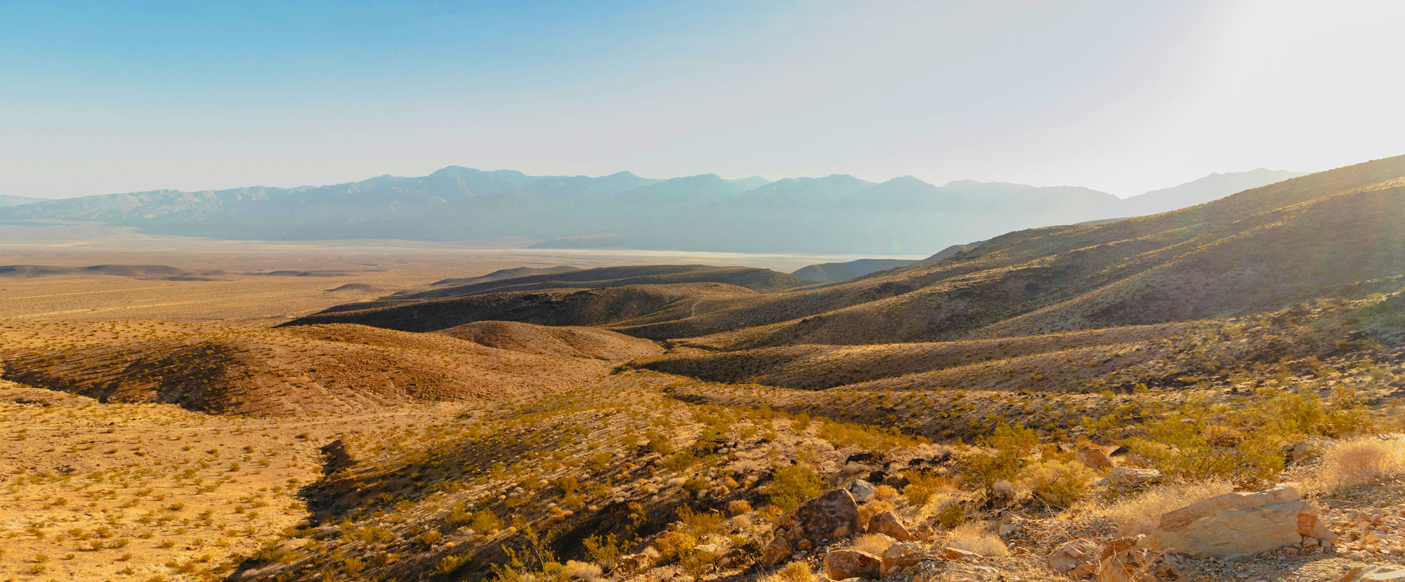 Sagebrush-covered hills and blue sky